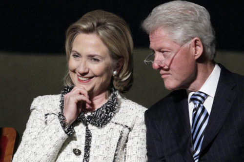 FILE - In this Jan. 14, 2011 file photo, then-Secretary of State Hillary Rodham Clinton, and former President Bill Clinton, listen to speakers in Washington. Clinton last left Iowa on an "excruciating" night, the beginning of the end of her White House campaign. She returns for the first time this weekend, not quite yet running for president, but sure to hear cheers from a crowd of Democrats hoping she will.  (AP Photo/Carolyn Kaster, File)
